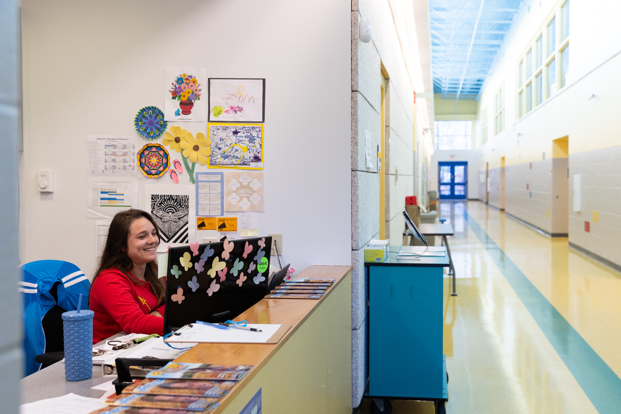 Photo of employee at front desk of preschool