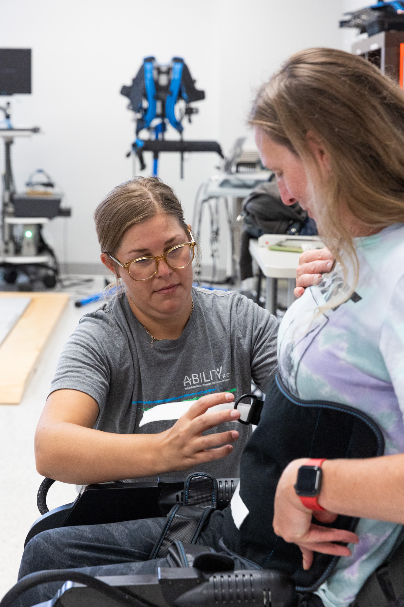 Close up of Therapist Natalie helping SCI patient into Ekso equipment